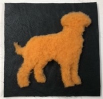 Texture wall hanging crafted with golden shearling and black garment leather